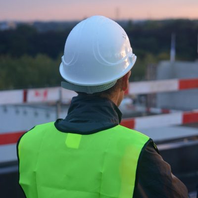Guy in hardhat working on a Michigan asphalt project