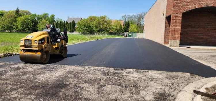 Asphalt Roller - Hartwick Asphalt and Sealcoating Equipment - rolling out pavement on a commercial job